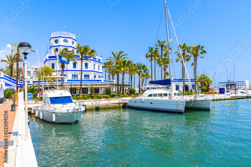 Boats and beautiful lighthouse building in Estepona port on Costa del Sol coast, Spain photo