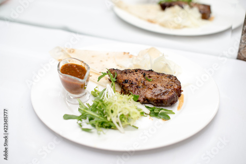 fried beef steaks with spices, on a white table