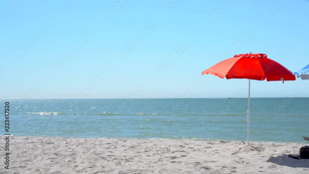 4K Red & Blue umbrellas and armchair on the beach 4K Red & Blue umbrellas and armchair on the beach