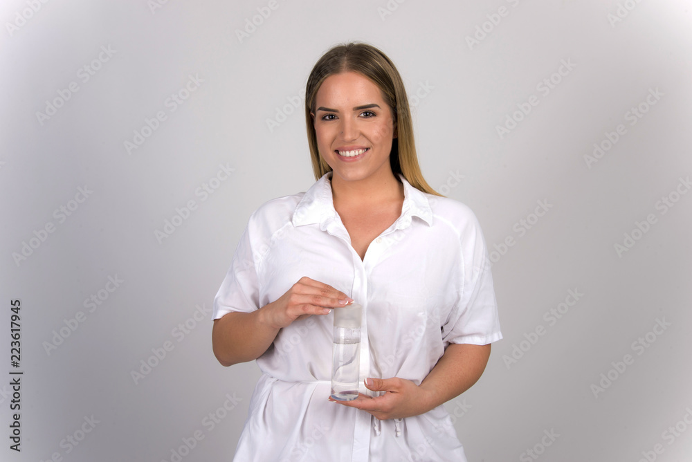 beautiful blond girl size plus model holding skin tonic micellar water in white skin dermatology concept beautiful blond girl size plus model holding skin tonic micellar water in white skin dermatology concept
