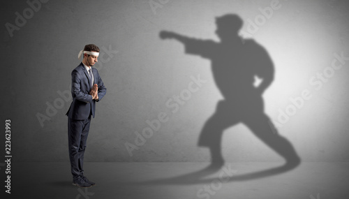 Photography Young karate man confronting with his own shadow