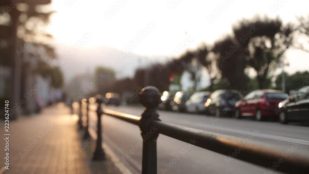 Cars are driving down the street during sunset in Italy Cars are driving down the street during sunset in Italy
