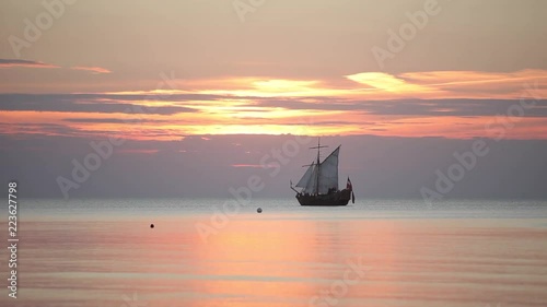 Sailing ship with masts in the sea at sunset in the Baltic Sea