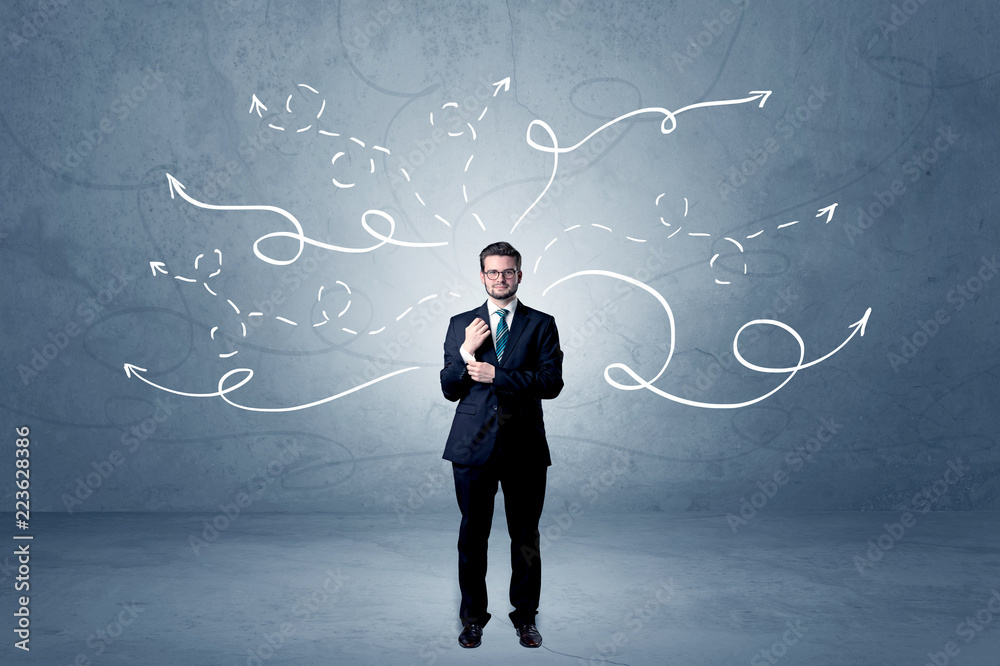 Elegant businessman choosing between directions with winding drawn arrows around
Elegant businessman choosing between directions with winding drawn arrows around
