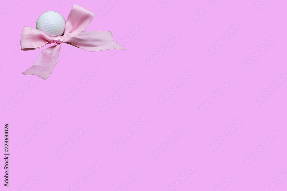 Golf ball with pink ribbon on pink background for golfer's girl baby shower