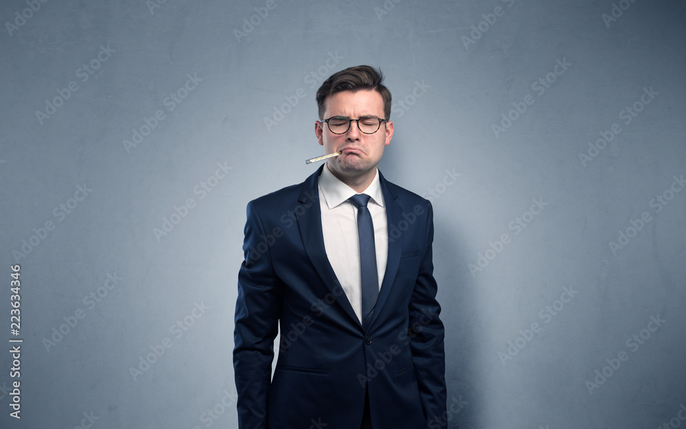 Young tired businessman with thermometer and copy space
Young tired businessman with thermometer and copy space