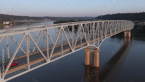 An aerial three-quarter profile view of traffic passing on a bridge over the Ohio River at dusk in western Pennsylvania. Pittsburgh suburbs.
 photo