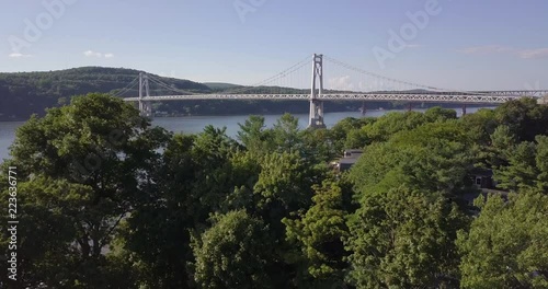 Drone move up from tree to reveal Hudson river and bridge
