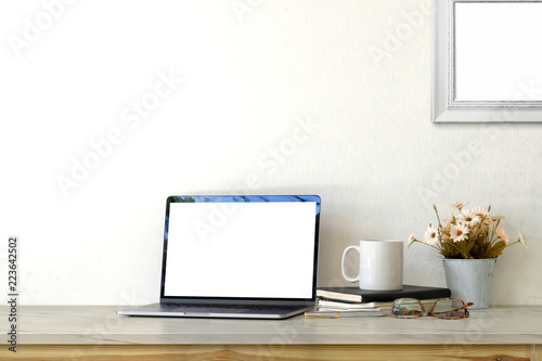 Workspace mockup blank screen laptop and supplies.