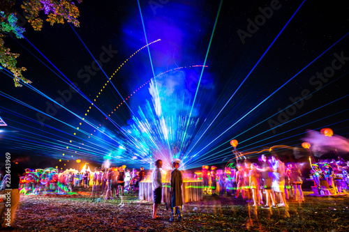 Fototapeta Outdoor night music party with laser lights and fire