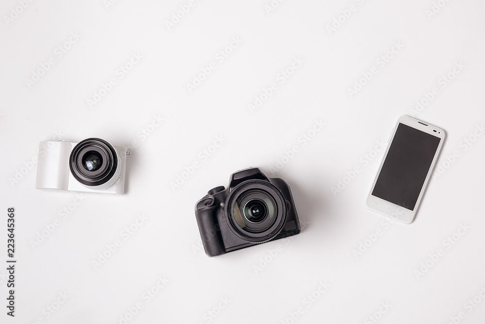 SLR camera and the smartphone was lying on a white background Stock Photo |  Adobe Stock