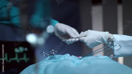 Surgeon operating hands. Close up of medical surgeon scalpel in hand. Nurse give scalpel to surgeon hand. Medical team hands performing operation. Surgery operation concept photo