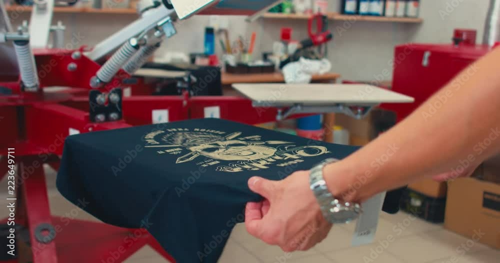 Silk screen printing process - making a print on a t-shirt. 4K UHD