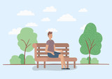 young man sitting on park chair