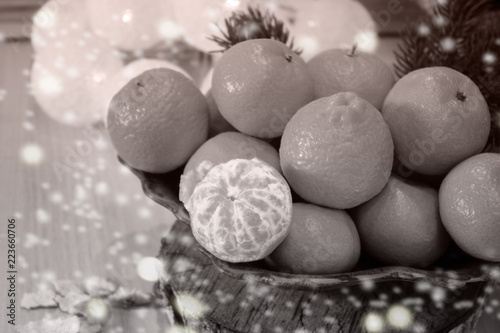 Decorative composition with tangerines. The concept of Christmas holidays..Black and white image.