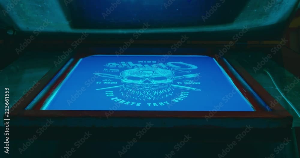 Silk screen printing process - forming a stencil from a screen with of a piece of mesh stretched over a frame. 4K UHD Silk screen printing process - forming a stencil from a screen with of a piece of mesh stretched over a frame. 4K UHD