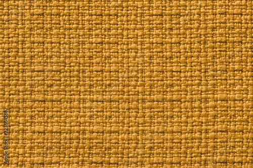 Dark yellow background from a textile material. Fabric with natural texture. Backdrop.