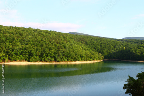 nice still lake with green hills in distance. natural landscape photo © Dancing Man