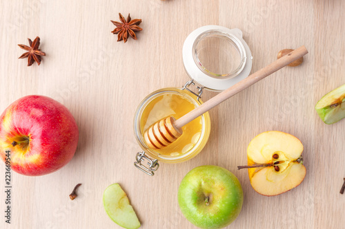 Fototapeta Naklejka Na Ścianę i Meble -  Jewish holiday Rosh Hashanah background with honey and apples on wooden table.