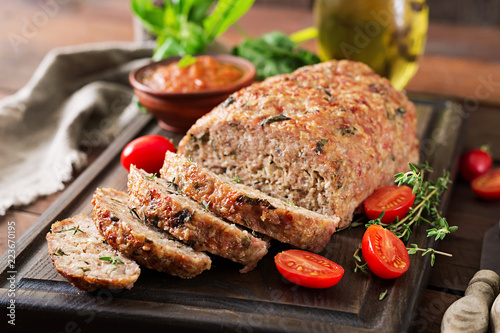 Tasty homemade ground  baked turkey meatloaf on wooden table. Food american meat loaf.