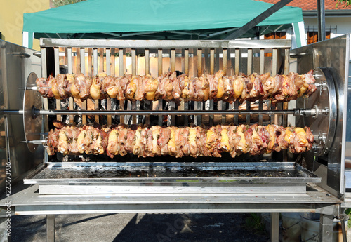 big spit with meat of pork and chicken at restaurant