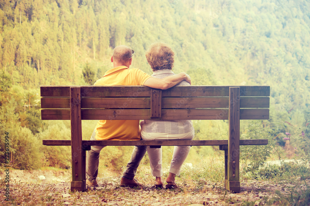 couple sitting outdoors in autumn, man holding his wife (romantic love concept)
couple sitting outdoors in autumn, man holding his wife (romantic love concept)