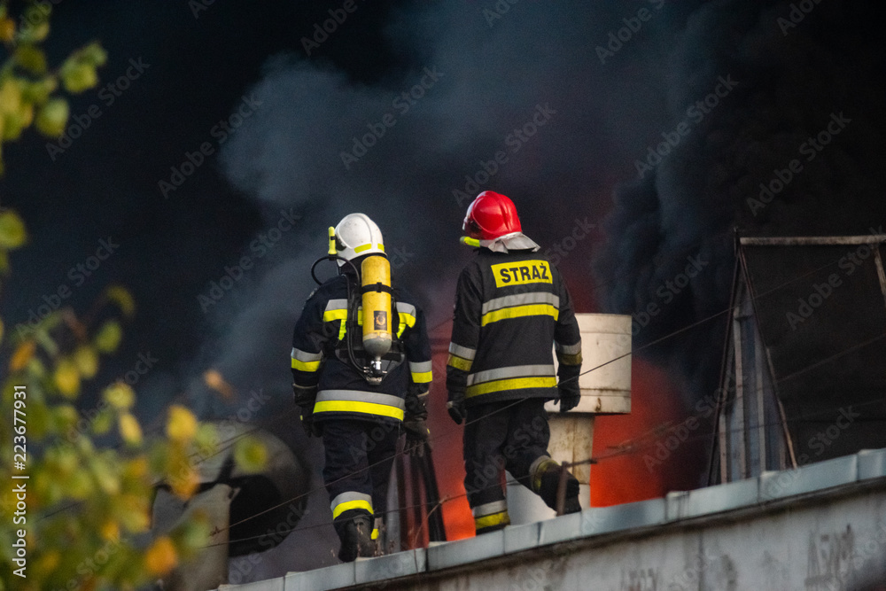 Fototapeta premium firefighters during the action of extinguishing a powerful fire of a recycling company.Poland, Szczecin
