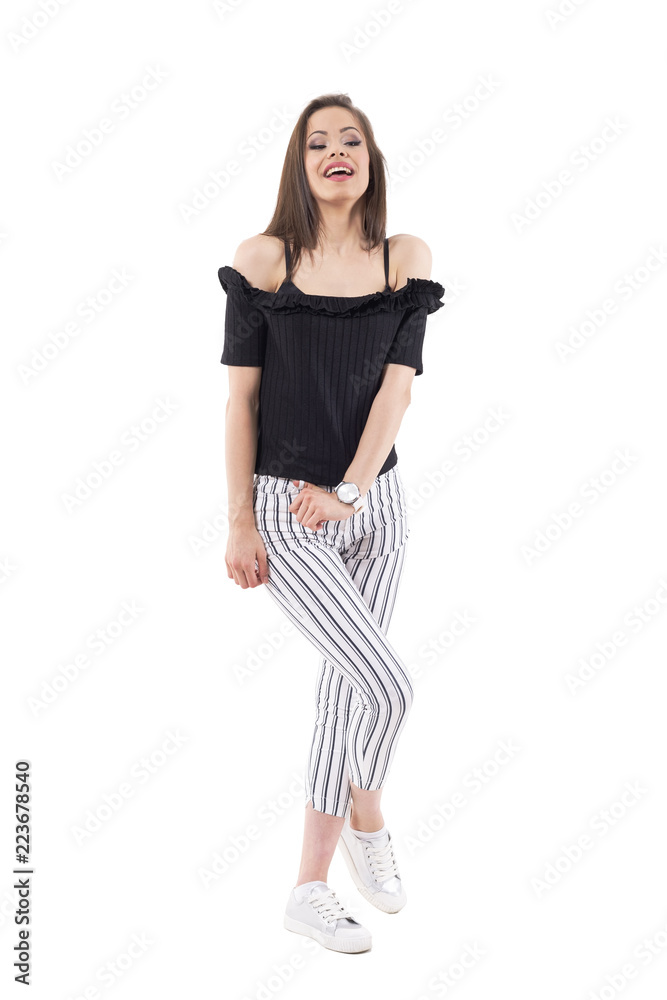 Stunning young trendy woman in stripped pants posing with mouth open and looking away. Full body isolated on white background. Stunning young trendy woman in stripped pants posing with mouth open and looking away. Full body isolated on white background.