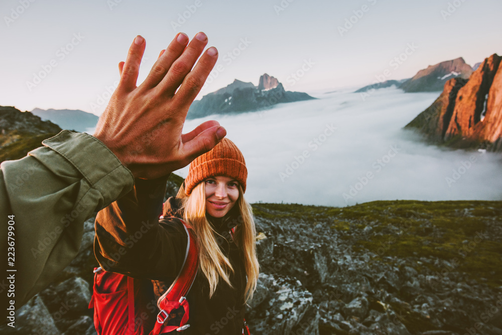 Travel couple friends giving five hands outdoor hiking in mountains adventure lifestyle positive emotions concept family together on journey vacations - obrazy, fototapety, plakaty 