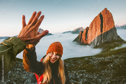 Fototapeta Naklejka Na Ścianę i Meble -  Couple friends giving five hands traveling outdoor hiking in Norway mountains adventure lifestyle positive emotions concept family together on journey vacations