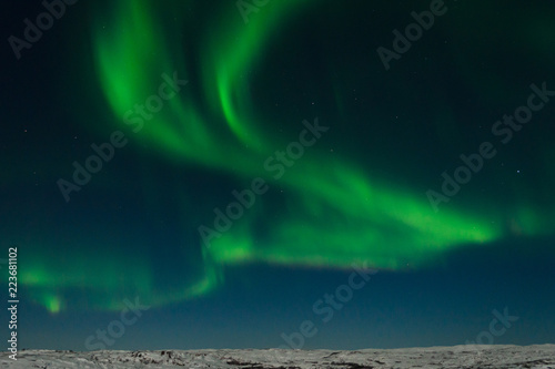 Aurora, Northern lights in the tundra in winter in the sky.