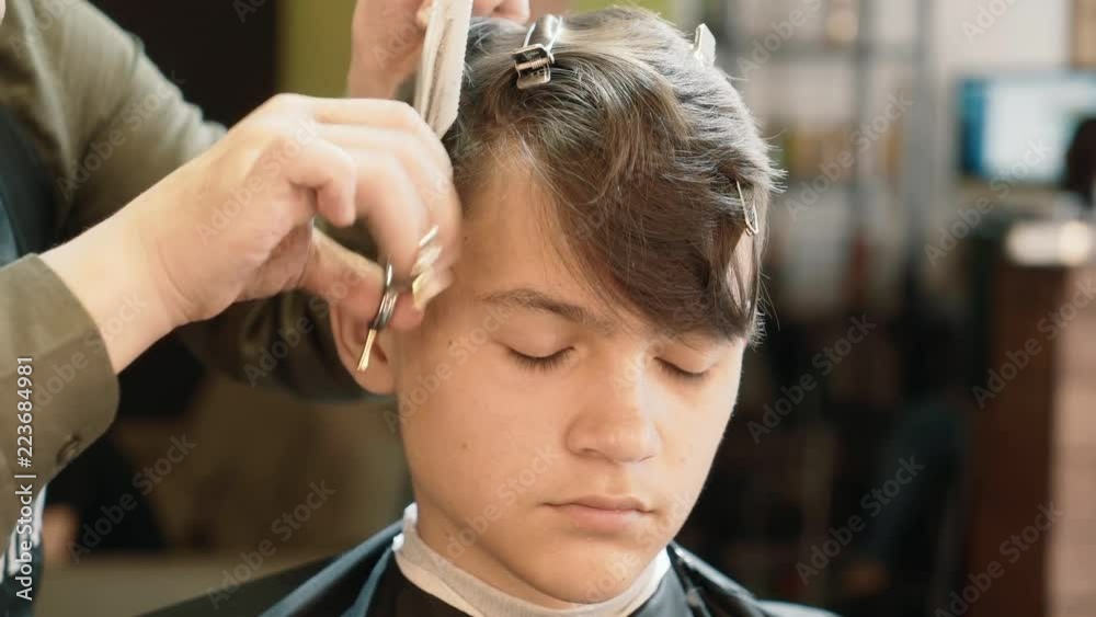 Hairdresser for men. Barbershop. A young man is cut hair in a hairdresser. Hairdresser for men. Barbershop. A young man is cut hair in a hairdresser.