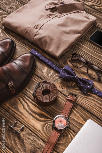 close up view of fashionable male clothing, accessories and digital devices on wooden surface