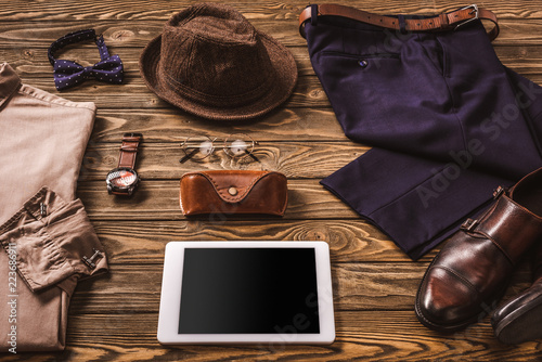 close up view of male accessories, stylish clothing and tablet on wooden tabletop