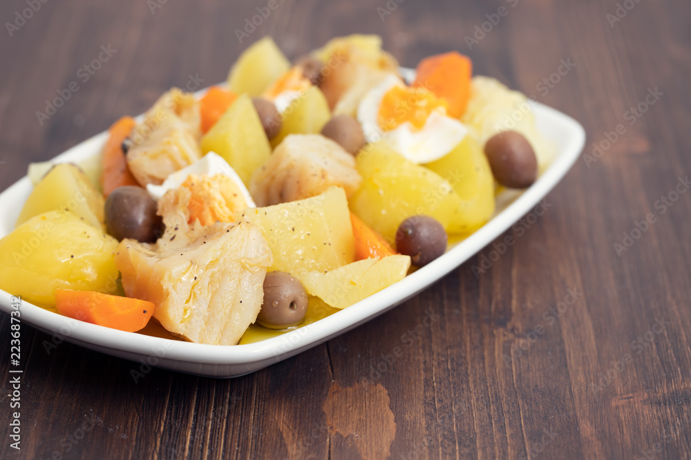 cod fish with boiled egg and vegetables on white dish cod fish with boiled egg and vegetables on white dish