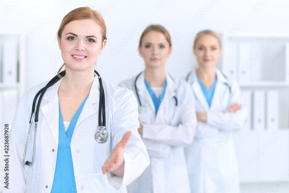 Group of medicine doctors offering helping hand for shaking hand or saving life. Partnership and trust concept in health care or medical cure Group of medicine doctors offering helping hand for shaking hand or saving life. Partnership and trust concept in health care or medical cure
