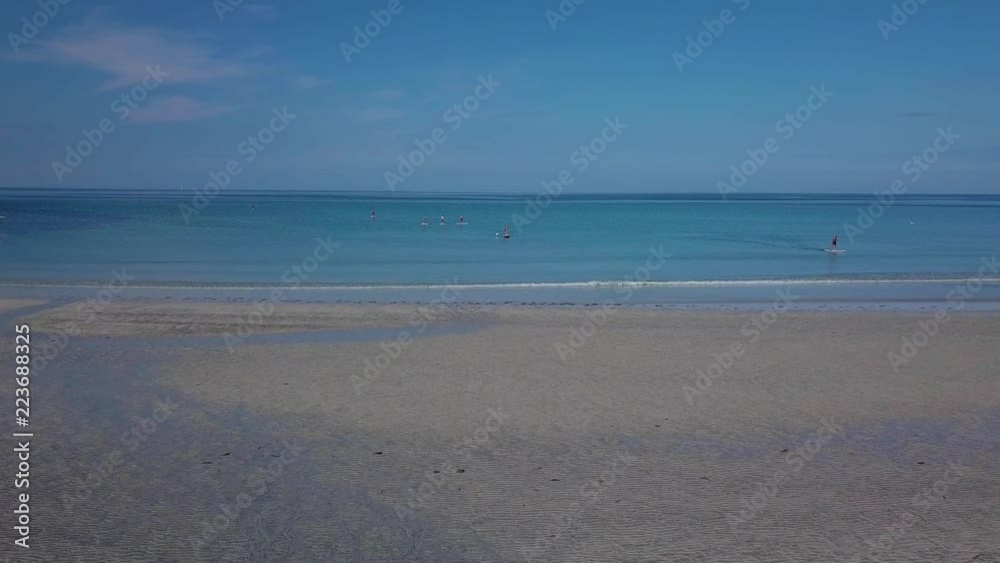 Flying over the sandy beach. People stand up paddling on vacation. The beautiful coast of Lofoten. Clear water and a mountain on the horizon. Norway 4k Flying over the sandy beach. People stand up paddling on vacation. The beautiful coast of Lofoten. Clear water and a mountain on the horizon. Norway 4k