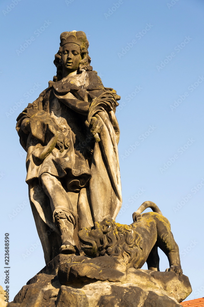 Statue of Saint Vitus from Ferdinand Maxmilian Brokoff 1714 on Charles Bridge near Mala Strana Bridge Tower, Prague, Czech Republic, sunny day, clear blue sky background
