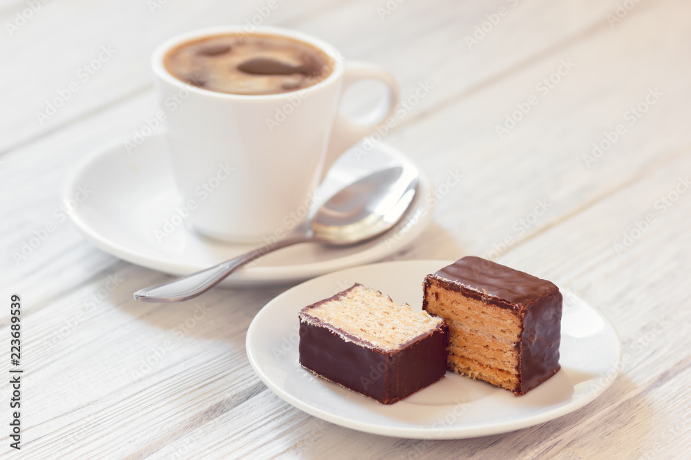 Slow morning with coffee and sweet wafers in chocolate coating Slow morning with coffee and sweet wafers in chocolate coating