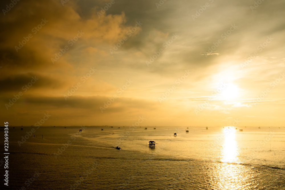 Sunset over the water with cloudy sky Sunset over the water with cloudy sky