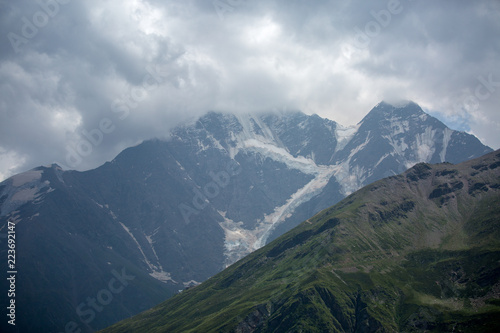 Fototapeta Naklejka Na Ścianę i Meble -  Image of mountain slopes with vegetation, cloudy sky