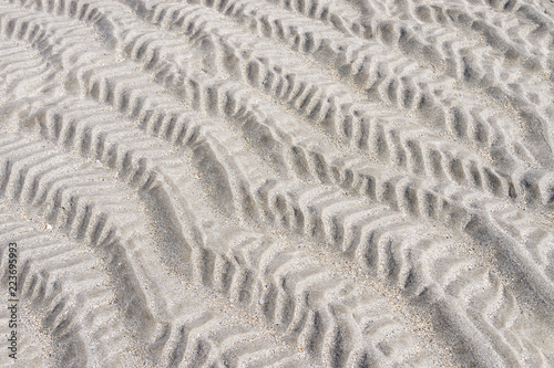 Abstract view of ripple texture left in the sand on a beach at low tide.