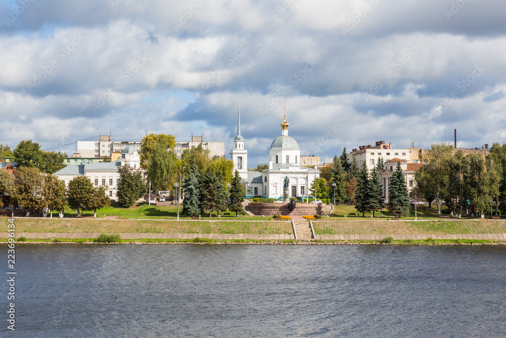 Fototapeta premium Left Bank of the Volga river in Tver, Russia. Resurrection Church (Church of the resurrection of Christ, the Church Of the three Confessors). Monument to Afanasy Nikitin, opened in 1955.