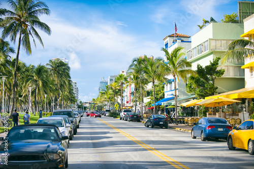 Early morning view down Ocean Drive lined with palm trees and art deco hotels in South Beach.