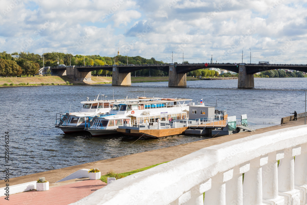 Embankment of the river Volga in Tver, Russia. Autumn Sunny day. Pleasure boats at the pier. The new Volga bridge.