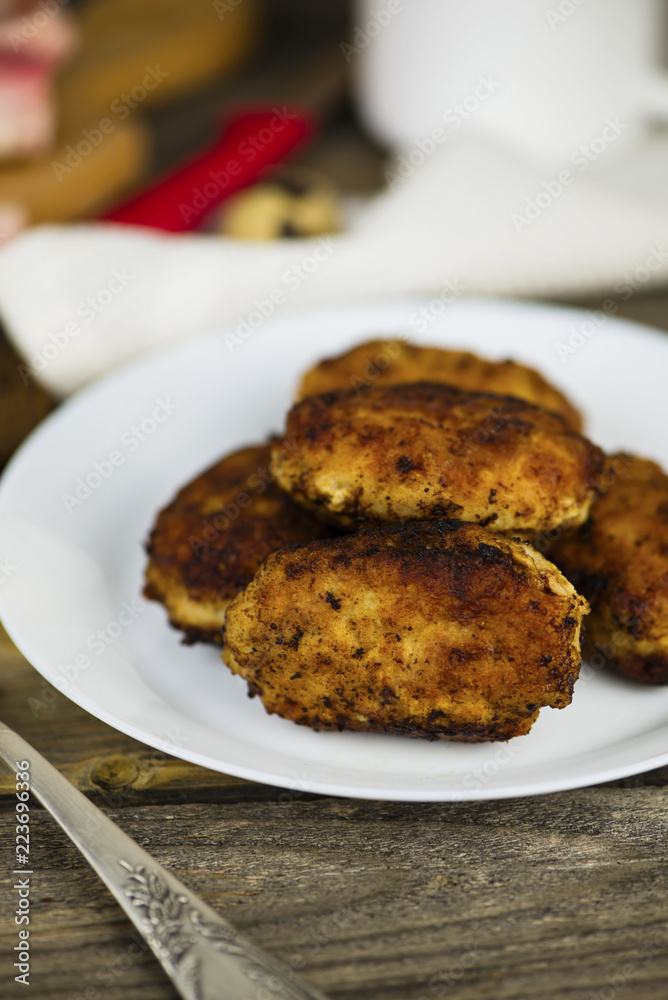 meat fried cutlets on a plate on a wooden board