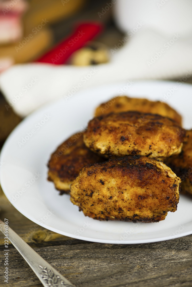 meat fried cutlets on a plate on a wooden board