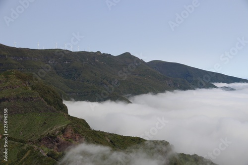 sea of clouds  mountains and windmills