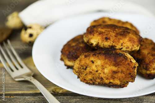 meat fried cutlets on a plate on a wooden board