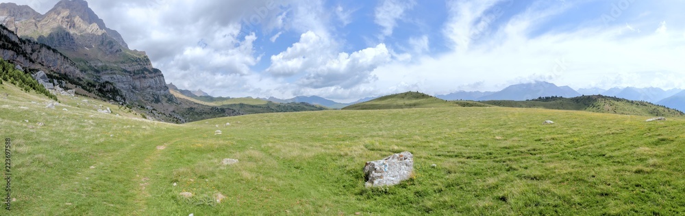 The mountains and the massif along the green path to the Piedrafita de Jaca lake in the aragonese Pyrenees mountains